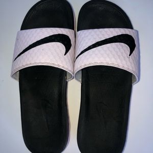 Pink and black nike slides